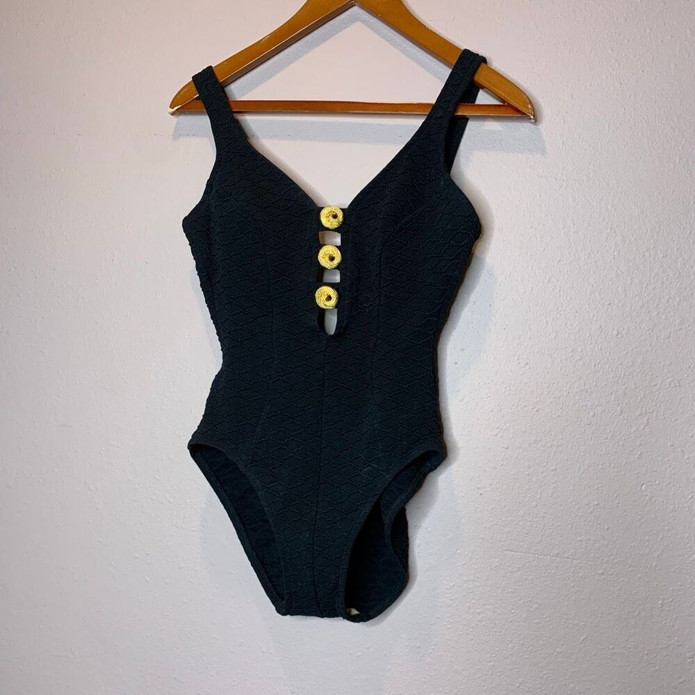 Mainstream vintage one-piece swimsuit features a textured fabric and gold button